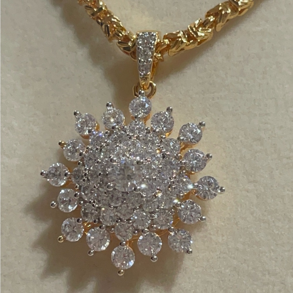 Brand new Ping Gold Tone Sunburst Pendant with Clear Stones